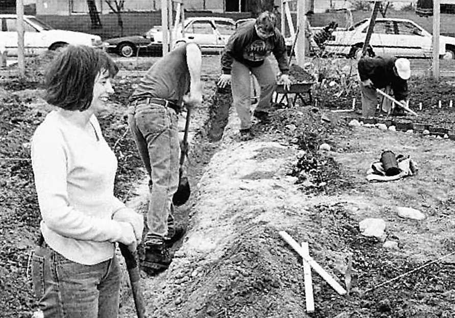 Photo of woman building the irrigation lines at Wall Street Community Garden, spring 2000.