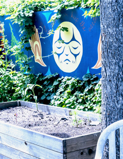 Photo of Indigenous mural along the back fence of Wall Street Community Garden, Vancouver.