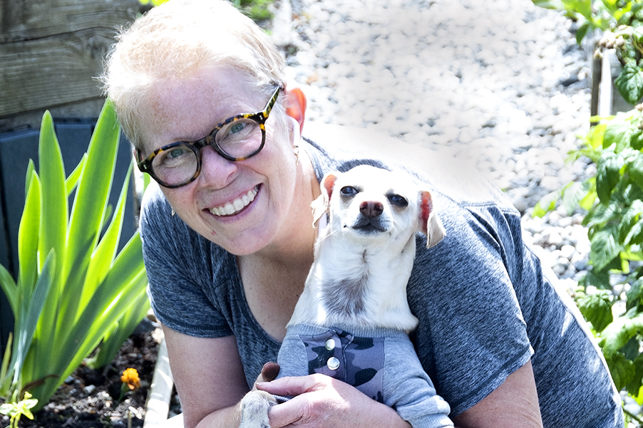Photo of Wall Street Community Garden member Suzanne and her dog, June 2024.