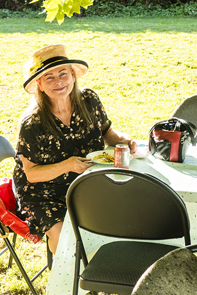 A member enjoys the potluck at Wall Street Community Garden.