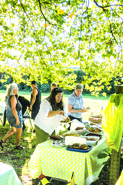Members enjoying the Wall Street Community Garden potluck.